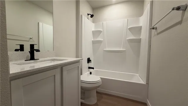 an empty room with a ceiling fan and wooden floor