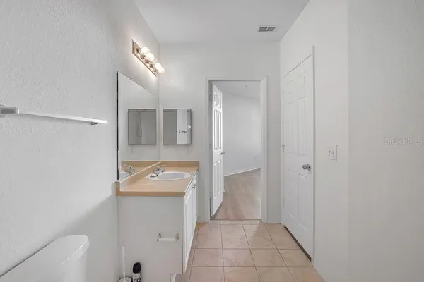 a bathroom with a sink and mirror