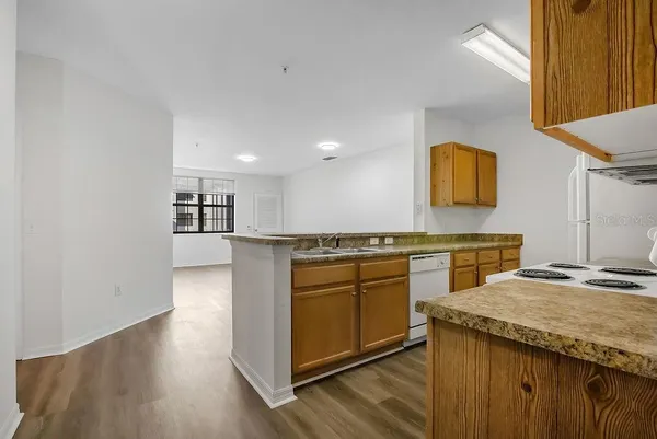 a kitchen with stainless steel appliances granite countertop a sink and a stove top oven