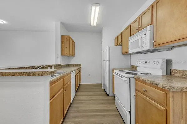 a kitchen with stainless steel appliances granite countertop a stove and a sink