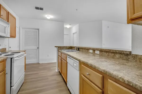 a kitchen with a sink and a stove top oven