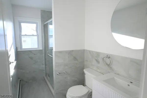 a bathroom with a toilet sink and shower