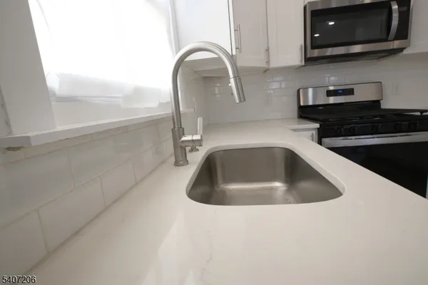 a kitchen with a sink and a microwave