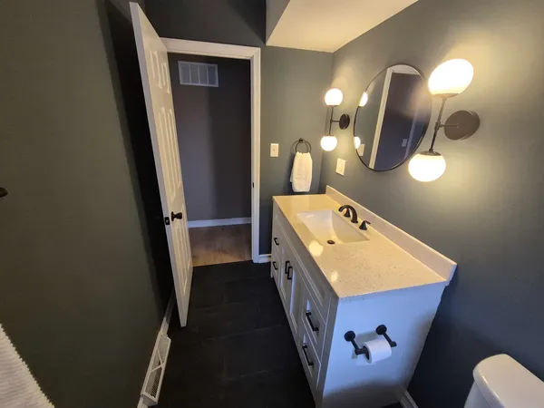 a bathroom with a sink and mirror