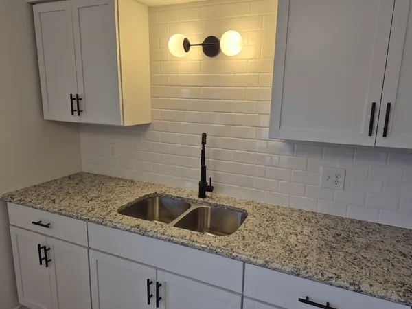a kitchen with a sink and cabinets