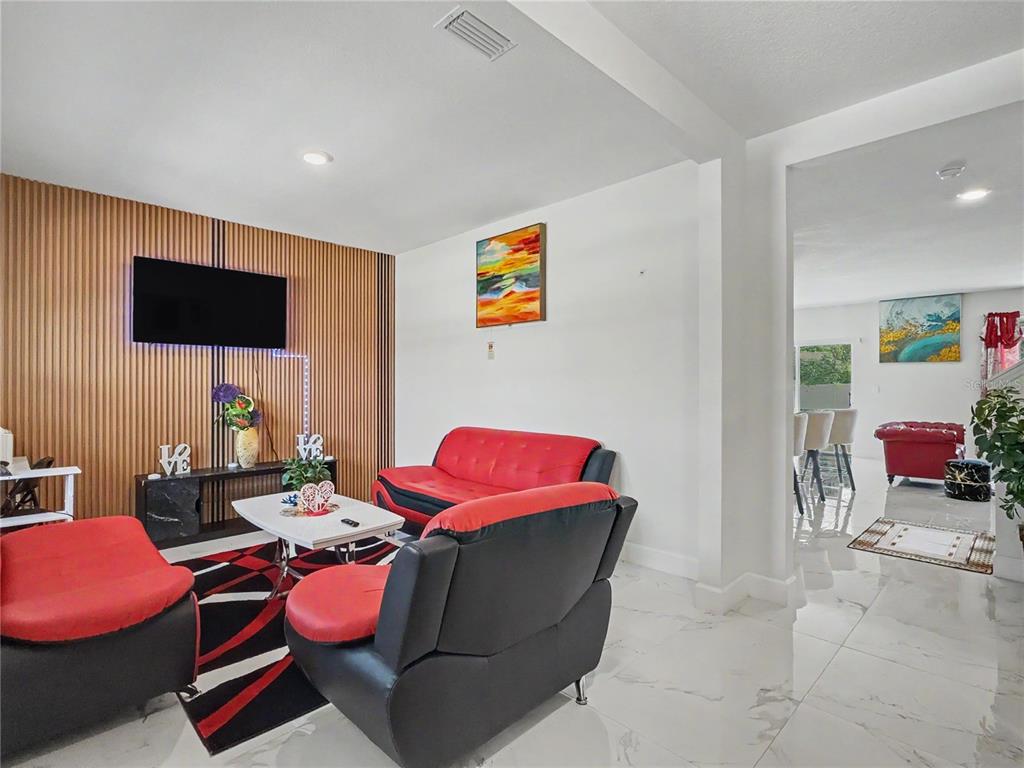 2085 Doe Run Drive Davenport, FL 33837 - Photo 8 of 44 a living room with furniture and a flat screen tv