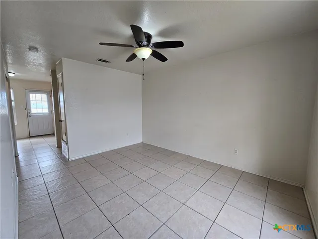a view of a livingroom with a ceiling fan and window