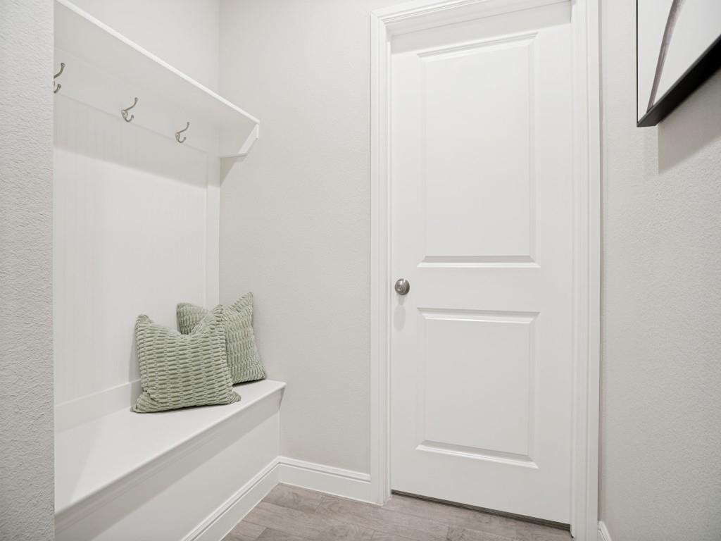 1612 Reed Drive Krum, TX 76249 - Photo 23 of 25 Built-in bench with upper shelving and coat hooks, complemented by wood-finish flooring