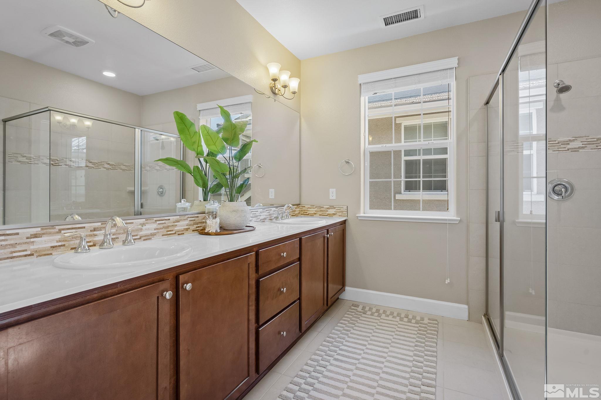 2041 Wind Ranch Road, Unit C Reno, NV 89521 - Photo 19 of 27 a bathroom with a double vanity sink and a mirror