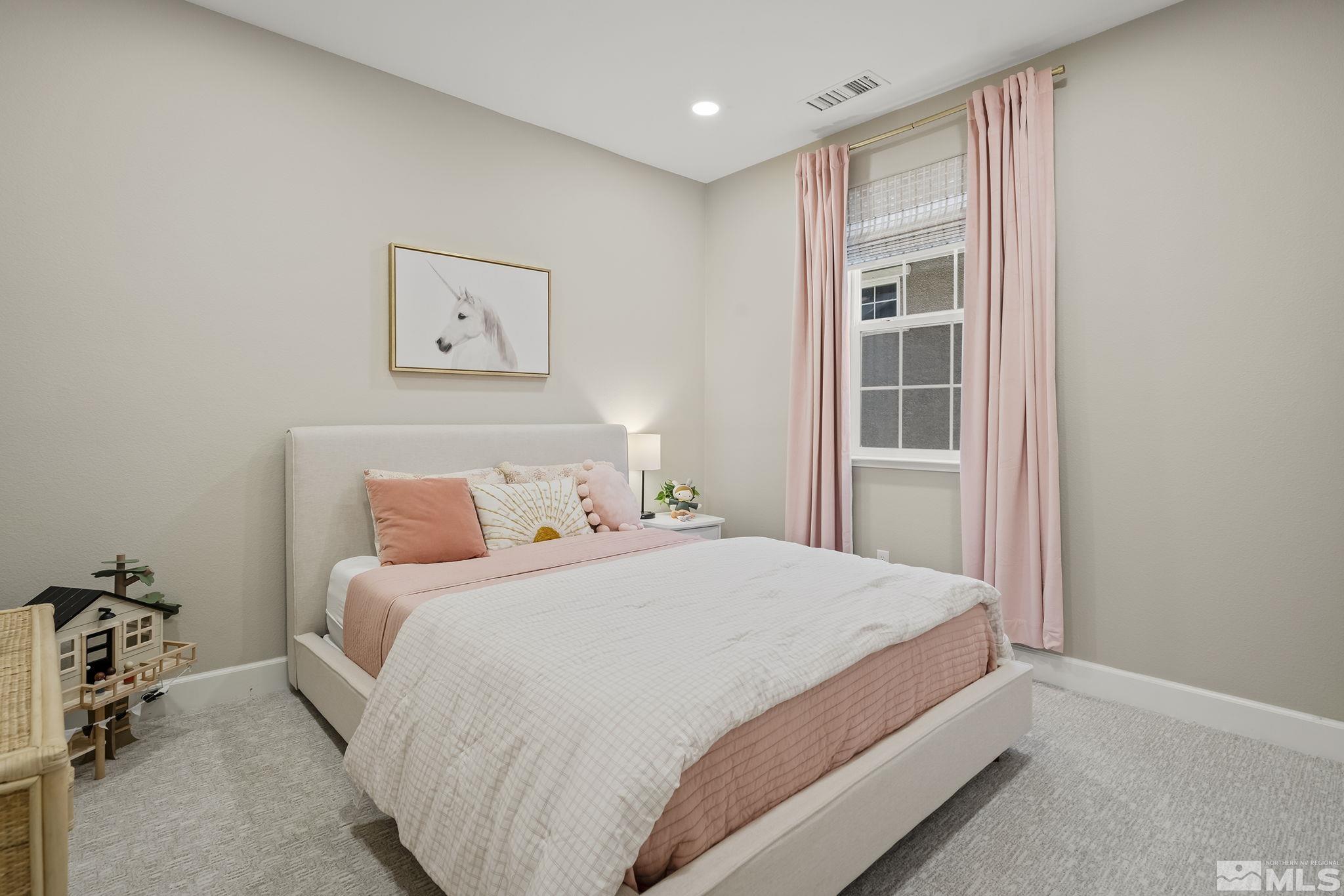 2041 Wind Ranch Road, Unit C Reno, NV 89521 - Photo 22 of 27 a bedroom with a bed and a window