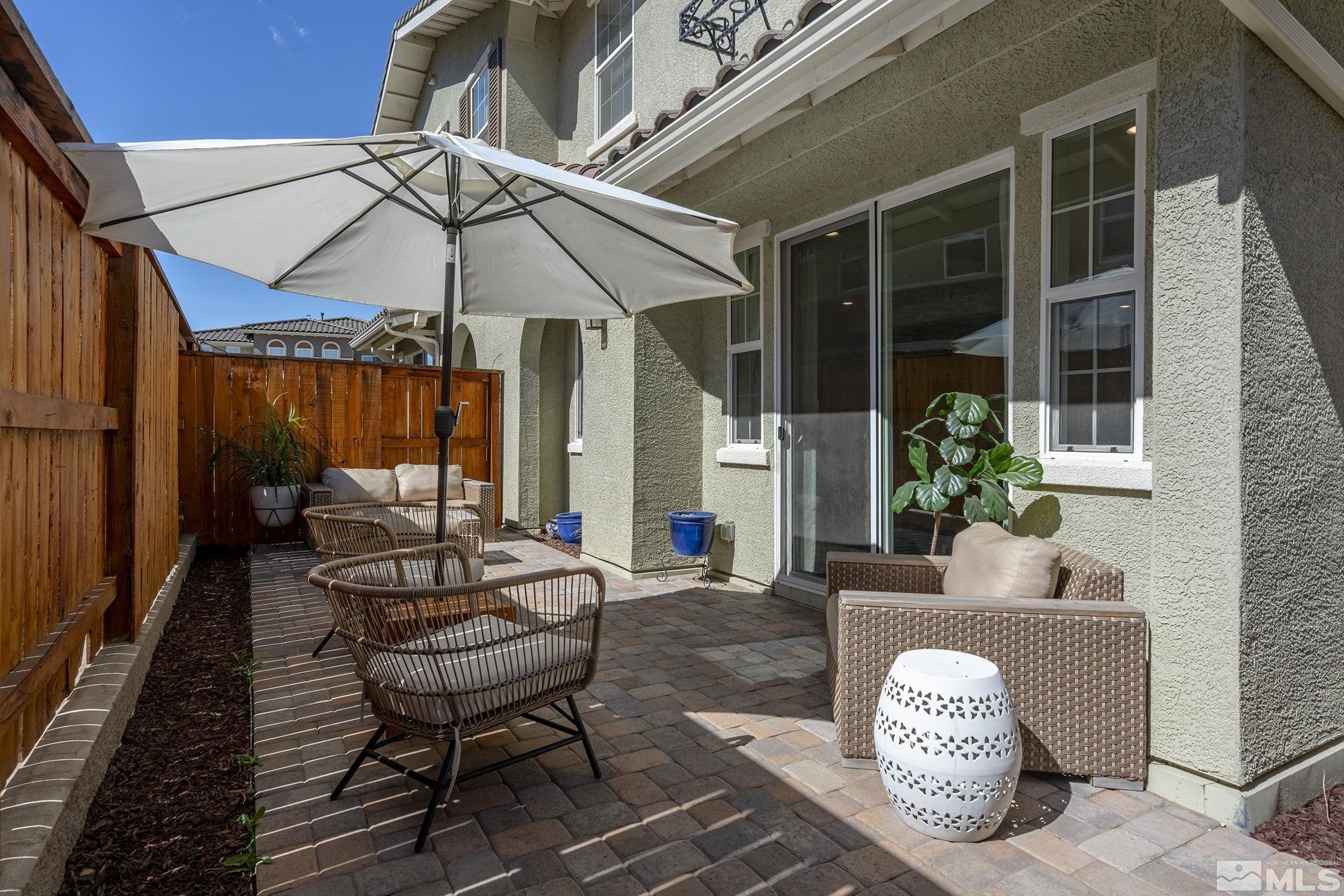 2041 Wind Ranch Road, Unit C Reno, NV 89521 - Photo 24 of 27 a backyard of a house with table and chairs