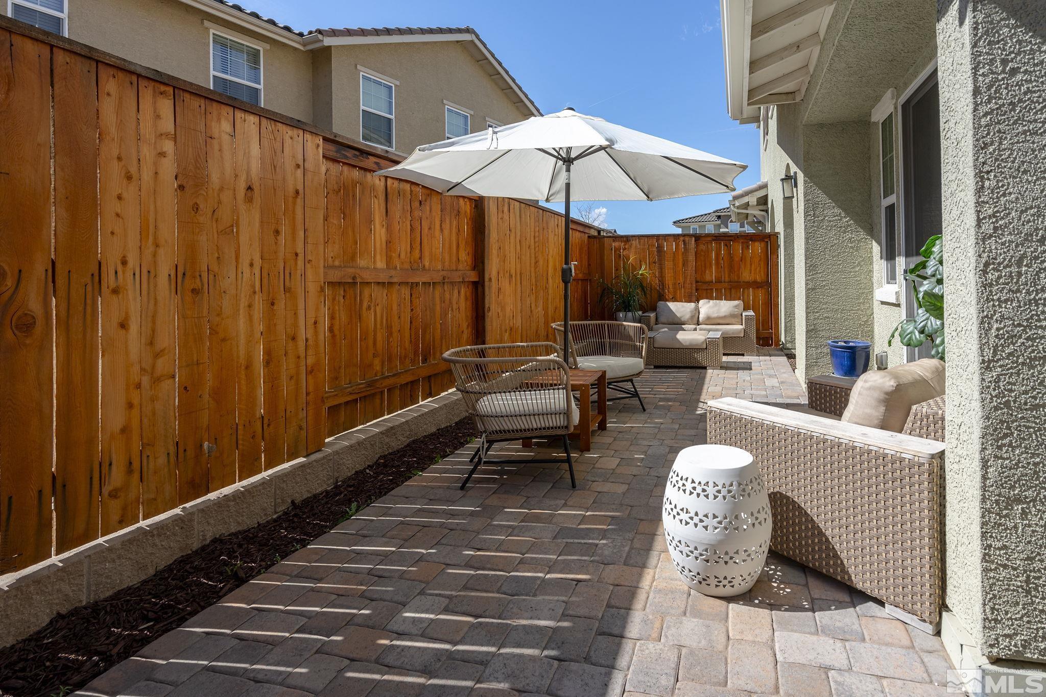 2041 Wind Ranch Road, Unit C Reno, NV 89521 - Photo 26 of 27 a couple of tables and chairs under an umbrella