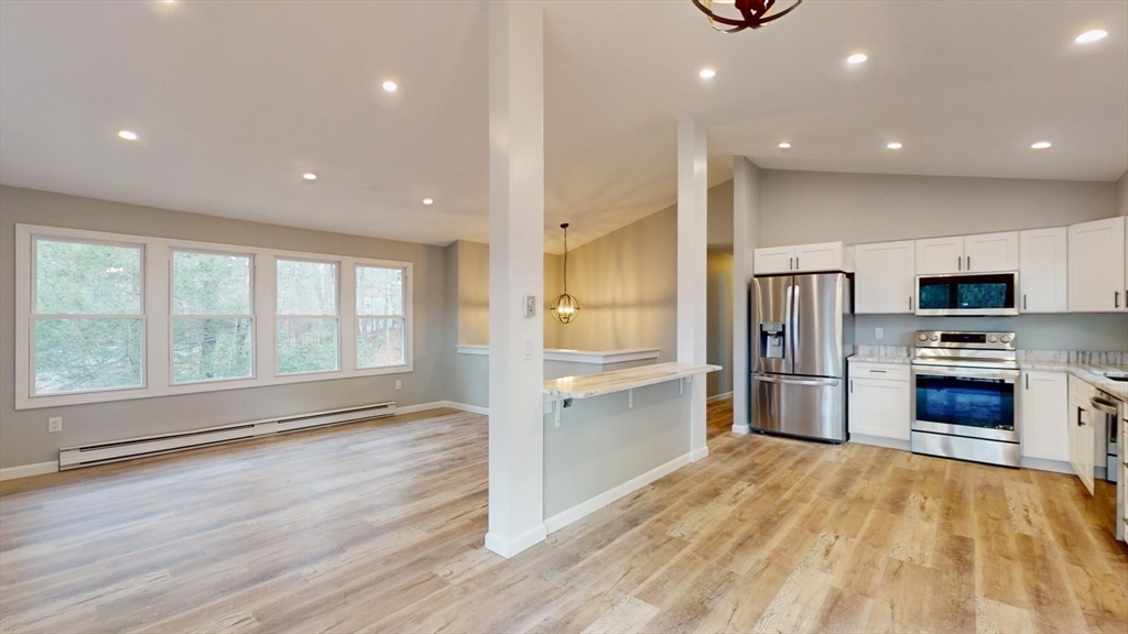 564 West Pelham Road Shutesbury, MA 01072 - Photo 8 of 40 a kitchen with stainless steel appliances a refrigerator and a stove top oven