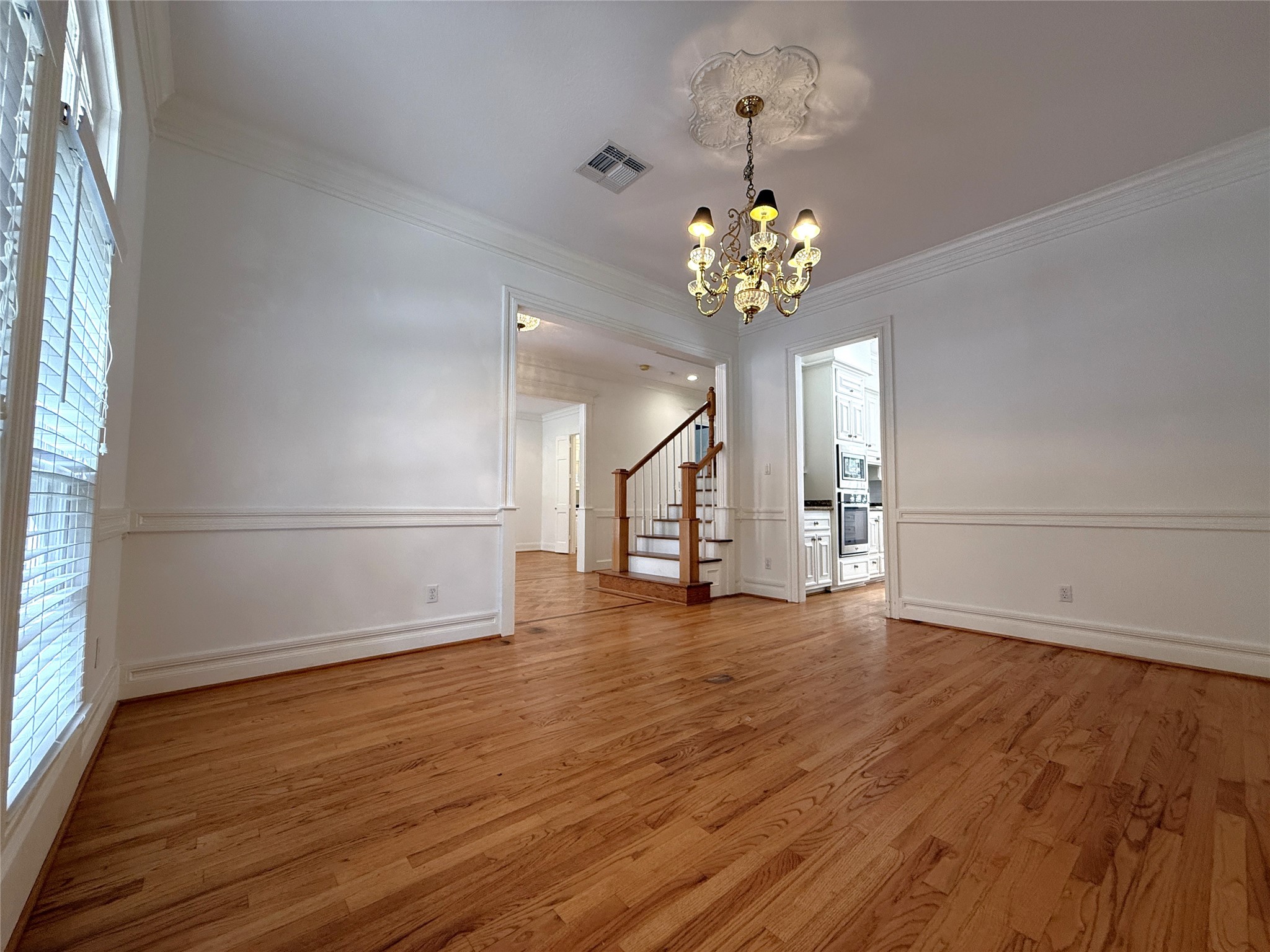 3024 Rice Boulevard Houston, TX 77005 - Photo 5 of 38 Crown molding & chair railing in the dining room.