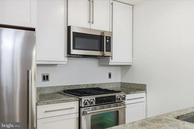 a view of a kitchen sink and cabinets
