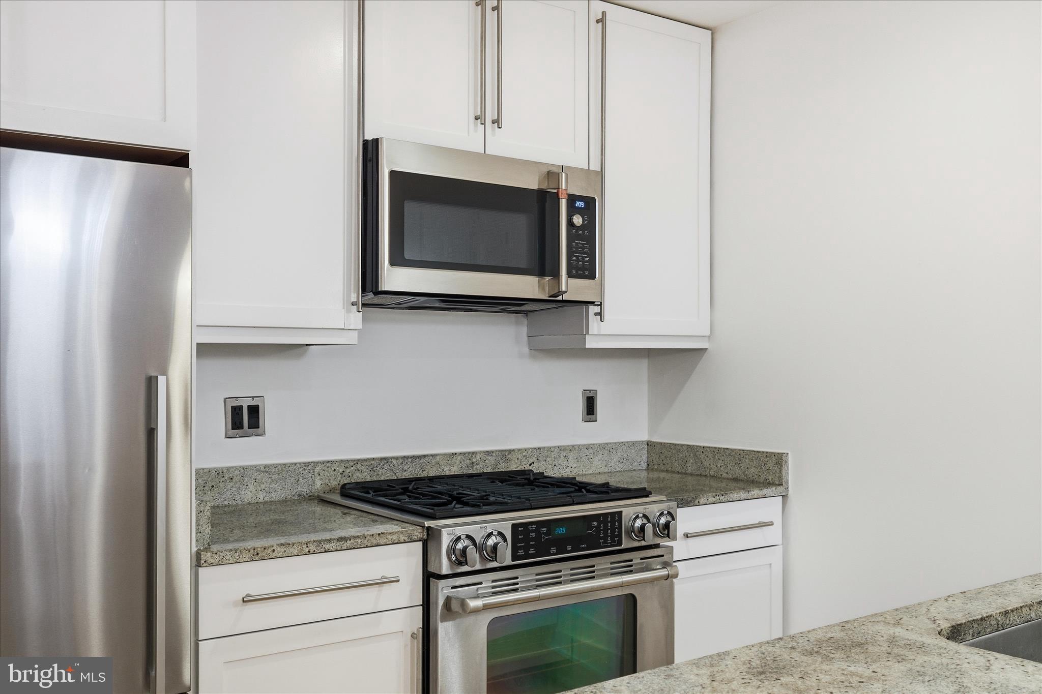 2818 Connecticut Avenue Northwest, Unit 5 Washington, DC 20008 - Photo 12 of 26 a kitchen with stainless steel appliances white cabinets and a stove top oven