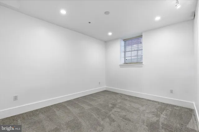 an empty room with closet and mirrors