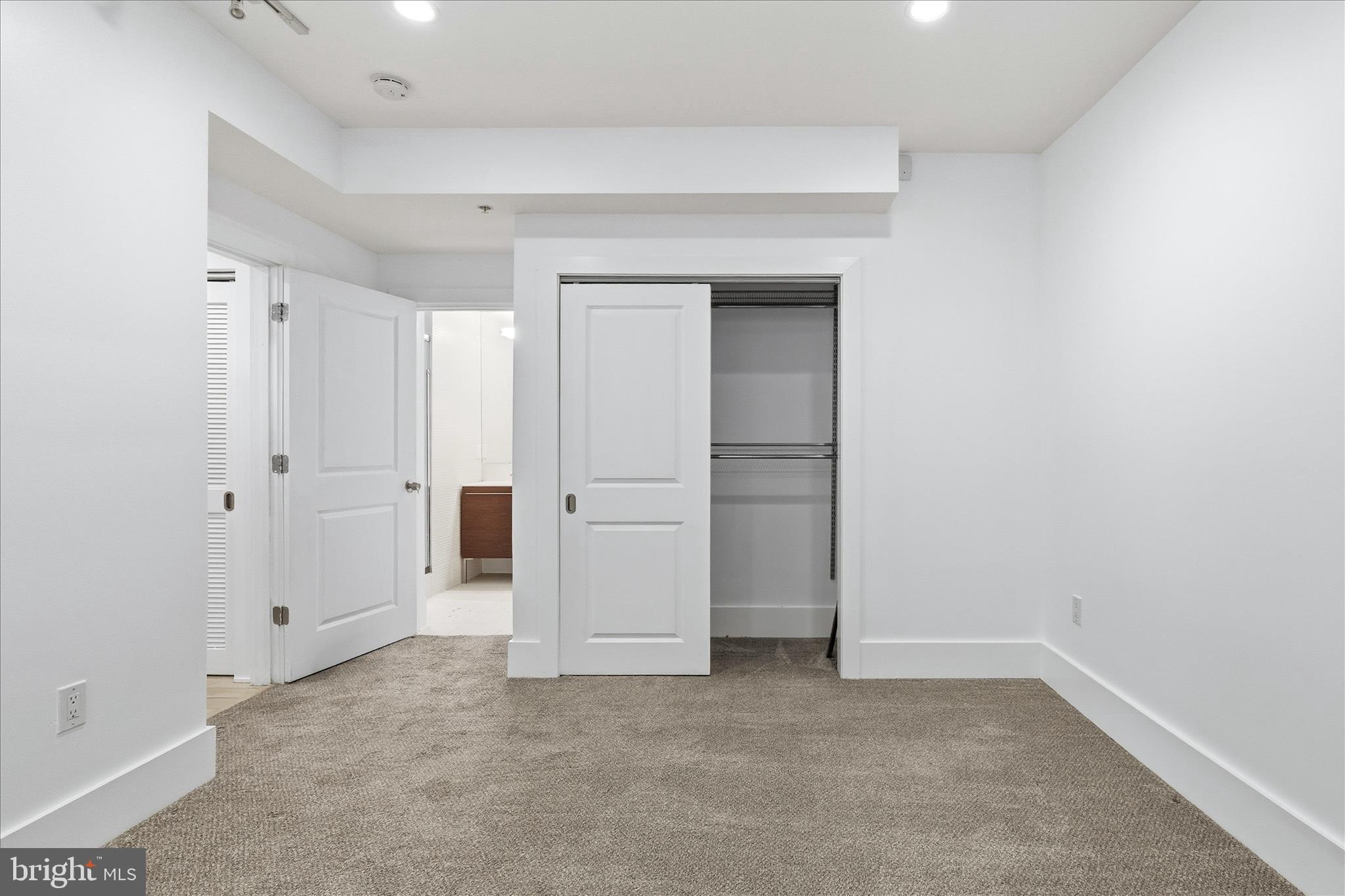 2818 Connecticut Avenue Northwest, Unit 5 Washington, DC 20008 - Photo 18 of 26 an empty room with closet and mirrors