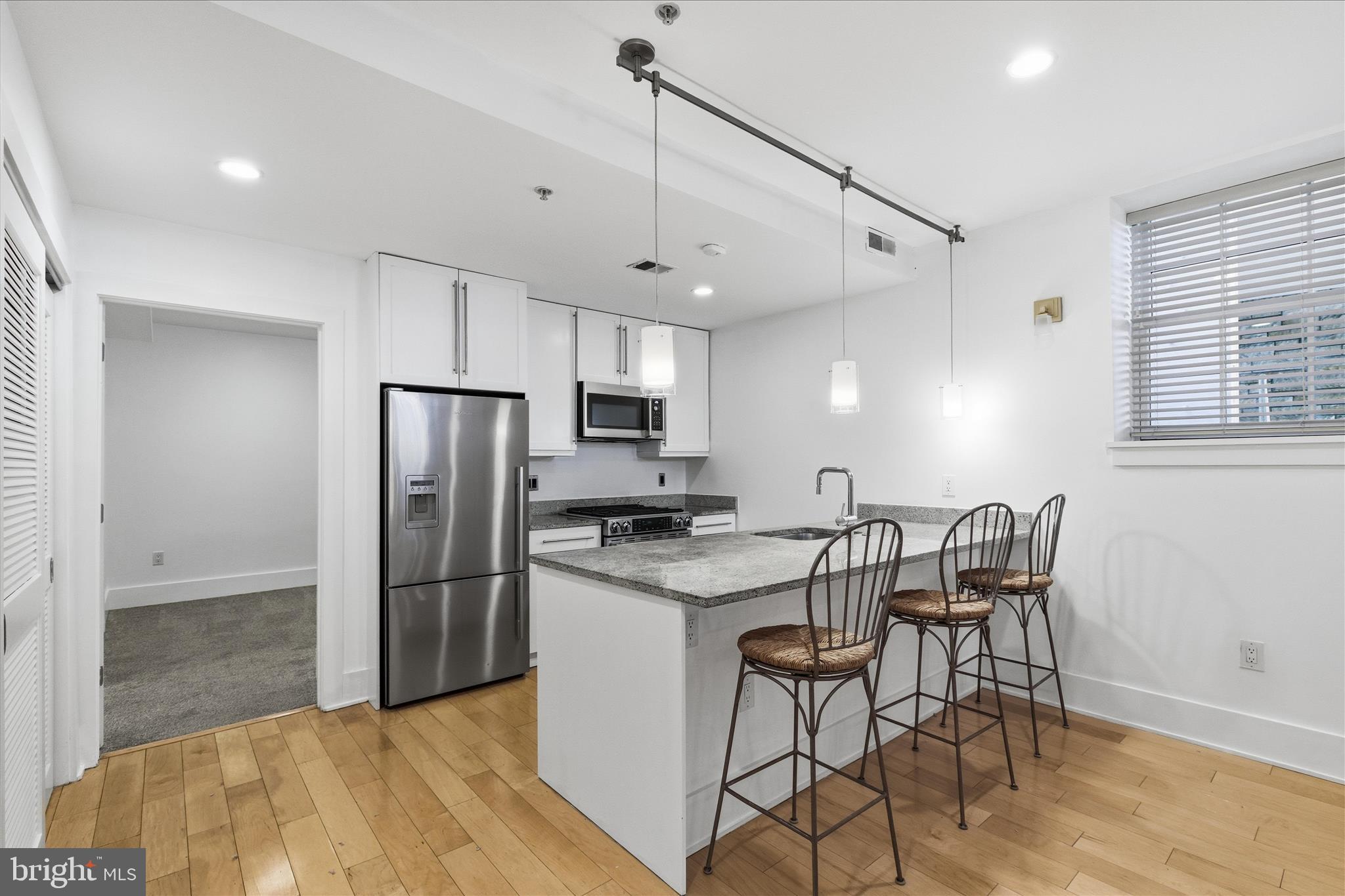 2818 Connecticut Avenue Northwest, Unit 5 Washington, DC 20008 - Photo 10 of 26 a kitchen with stainless steel appliances granite countertop a stove a refrigerator and a refrigerator