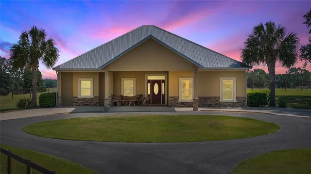 a view of a house with swimming pool and yard