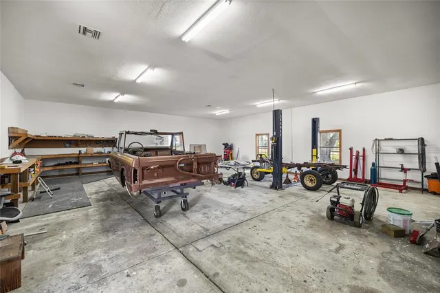 a room with lots of swings and a table and chairs