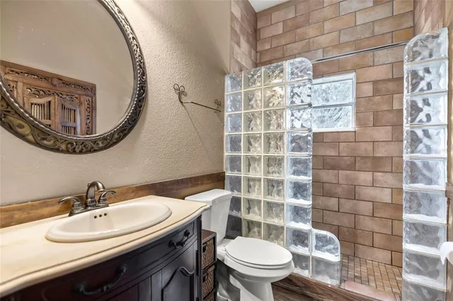 a bathroom with a sink a toilet and a mirror