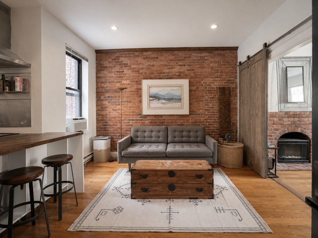 9 Albemarle Street, Unit 2 Boston, MA 02115 - Photo 4 of 11 a living room with furniture and a fireplace