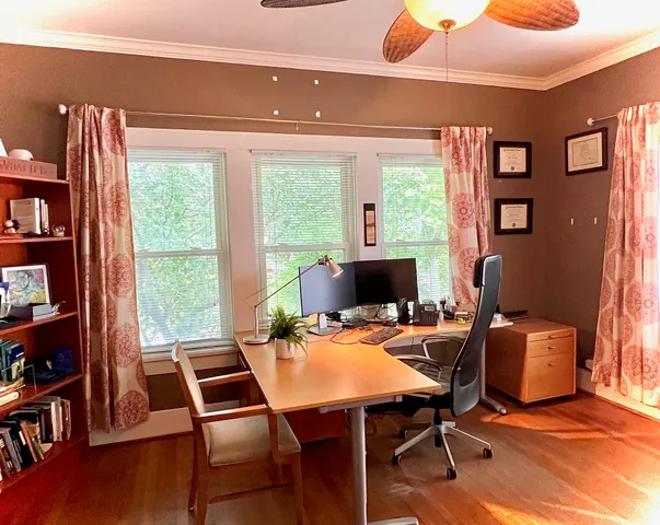 a view of a workspace with furniture and a window