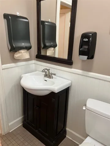 a bathroom with a toilet sink and mirror