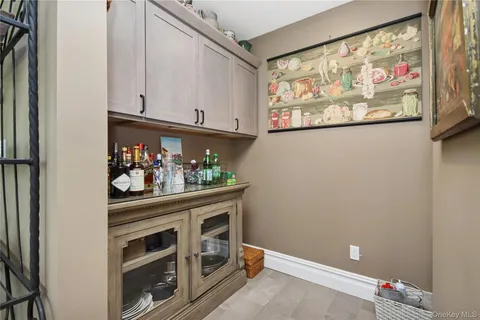 a room with painting on the wall and a potted plant