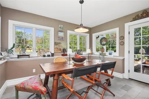 a dining room with furniture a chandelier and wooden floor