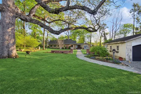 a front view of a house with a yard table and chairs