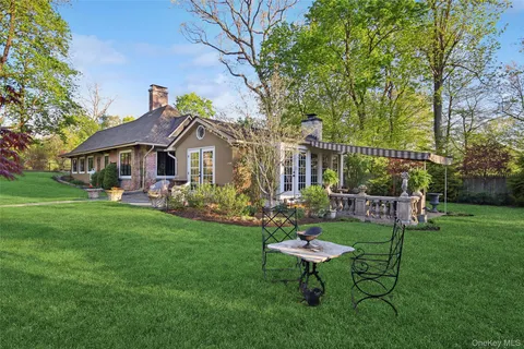 a view of a house with a backyard porch and sitting area