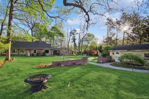 a view of a chair and table in backyard of the house