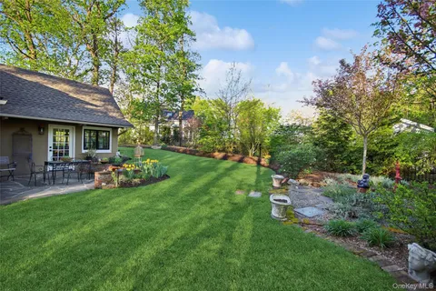 a view of a house with a yard and sitting area