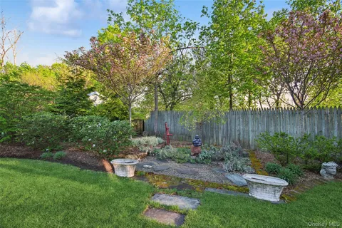 a view of a house with a yard and a garden