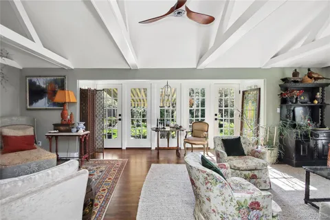 a living room with furniture large window and flat screen tv