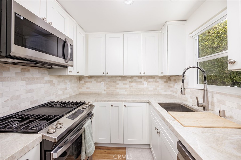 2260 Crestview Drive, Unit B Laguna Beach, CA 92651 - Photo 11 of 21 a kitchen with stainless steel appliances granite countertop a sink stove and microwave