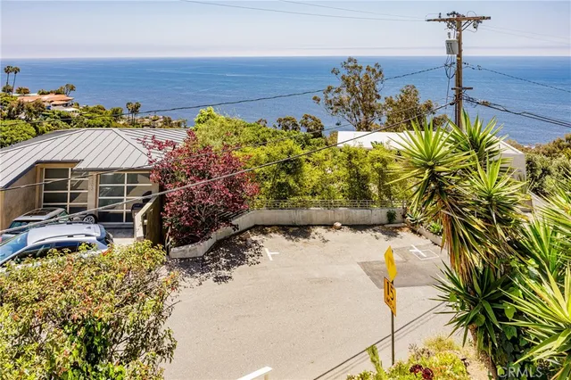 a view of a house with a yard and a bench