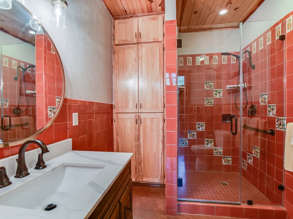254 Middleton Road Spicewood, TX 78669 - Photo 17 of 32 a bathroom with a sink and a shower