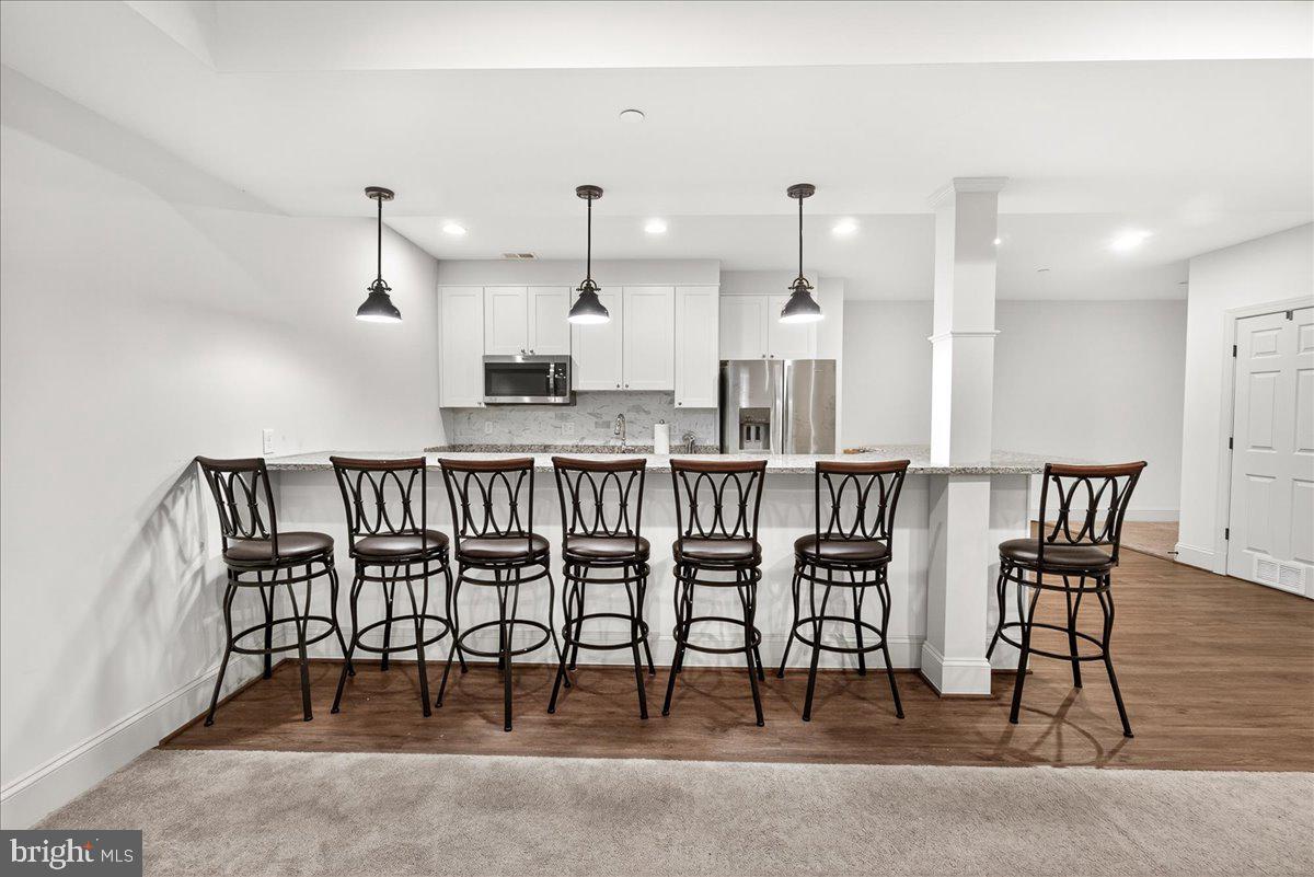 2516 Daisy Road Woodbine, MD 21797 - Photo 39 of 78 Sleek modern kitchen with bar seating.