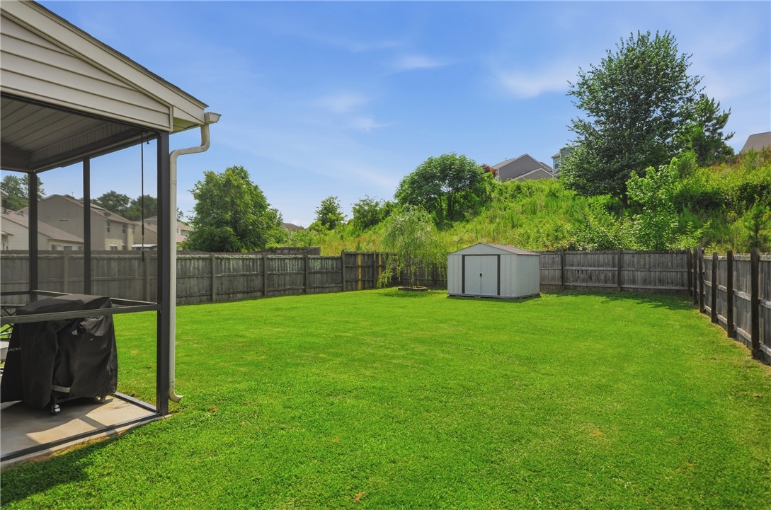 347 Riverdale Road Simpsonville, SC 29680 - Photo 23 of 30 A spacious backyard provides ample green space and a sheltered patio area, ideal for outdoor leisure.