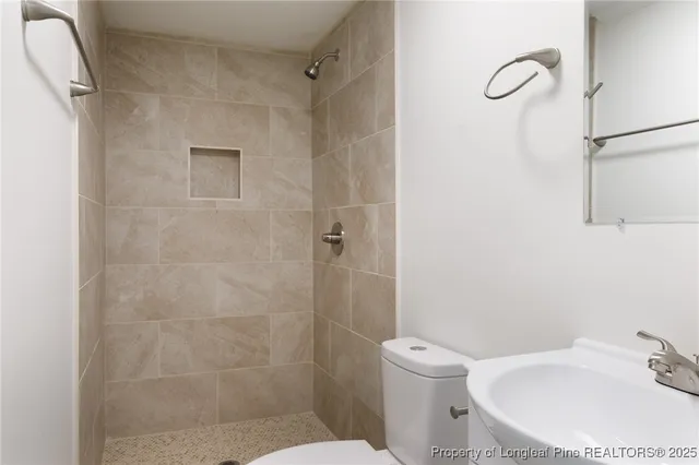 a bathroom with a toilet sink and shower