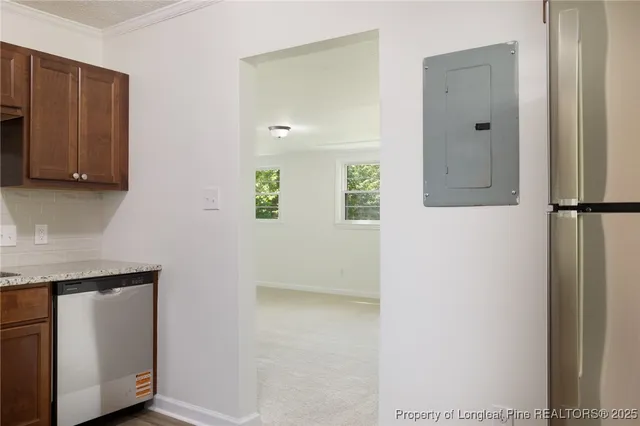 a view of an empty room with closet and a window