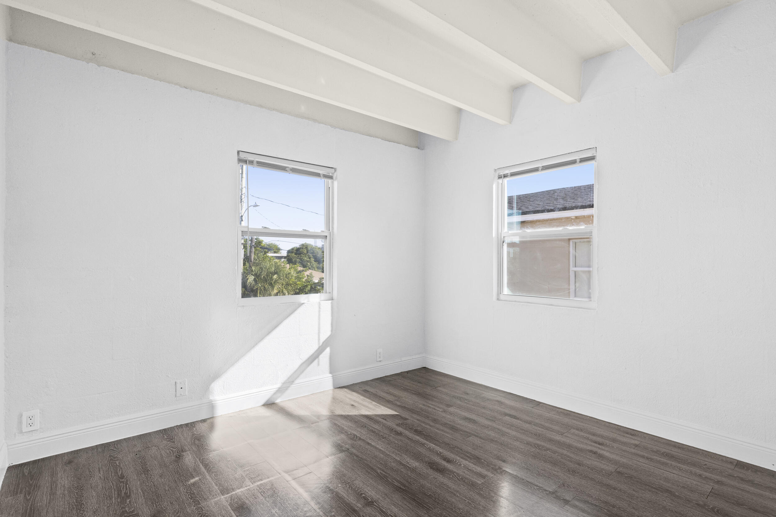 812 19th Street, Unit 3 West Palm Beach, FL 33407 - Photo 5 of 11 an empty room with wooden floor and windows