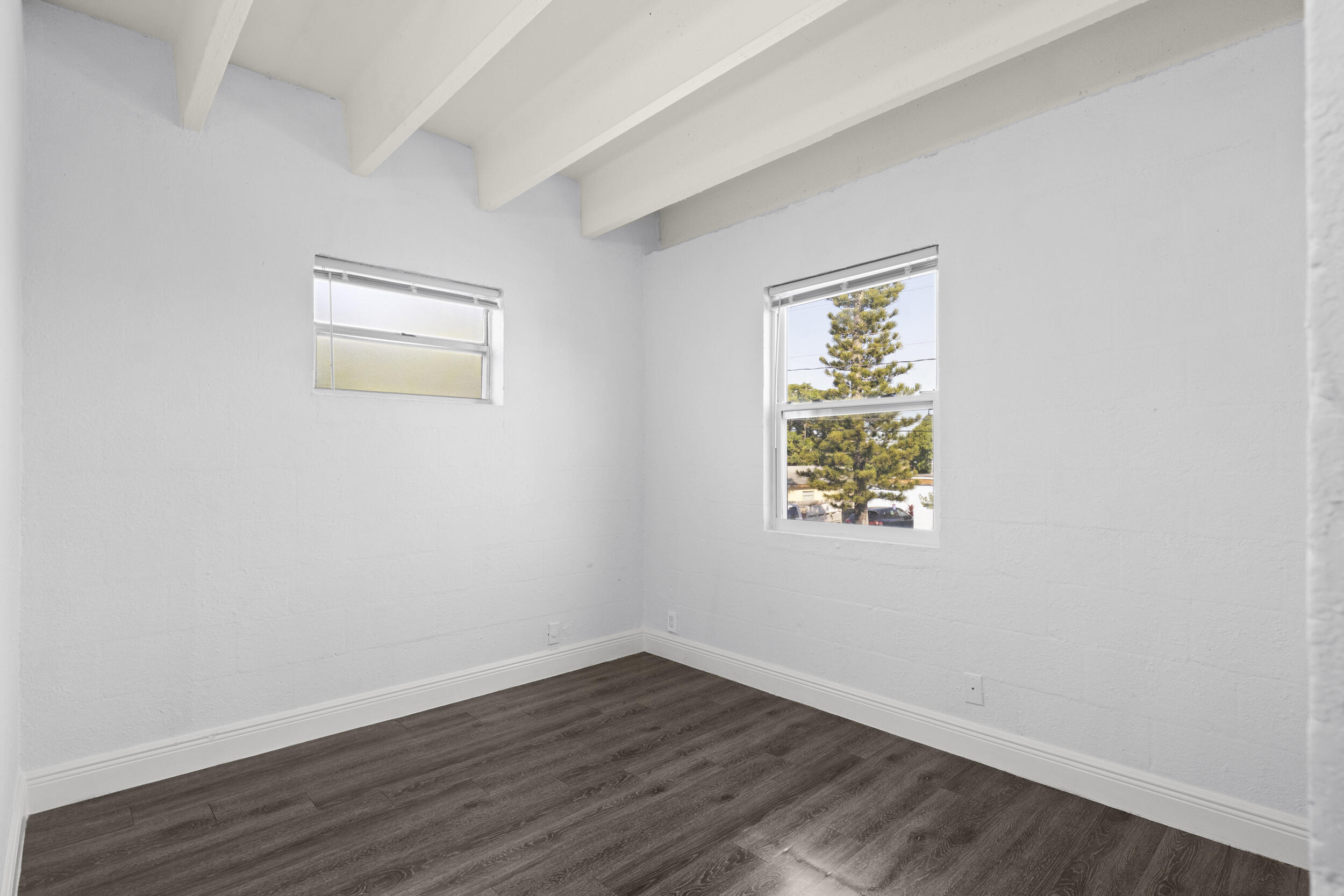 812 19th Street, Unit 3 West Palm Beach, FL 33407 - Photo 7 of 11 an empty room with wooden floor and windows