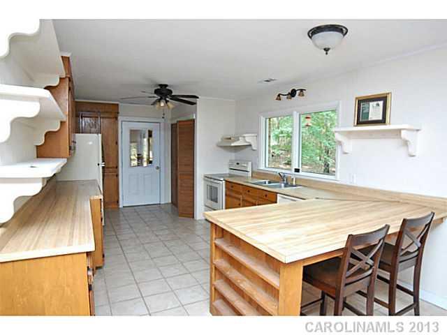 5413 Stone Mill Road Waxhaw, NC 28173 - Photo 4 of 16 a view of kitchen island with furniture and wooden floor