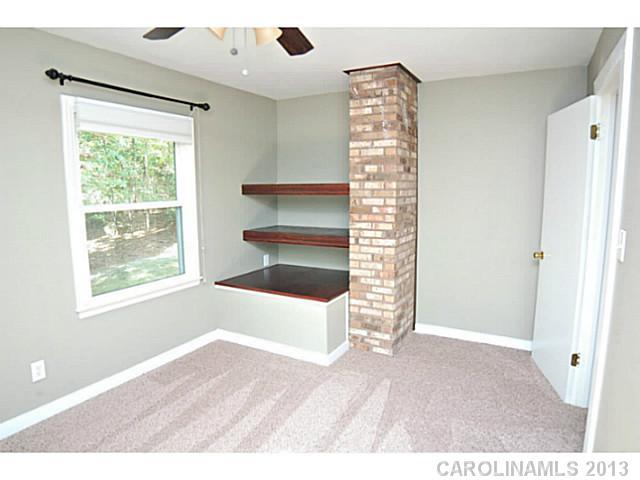 5413 Stone Mill Road Waxhaw, NC 28173 - Photo 7 of 16 a view of an empty room with a fireplace and a window
