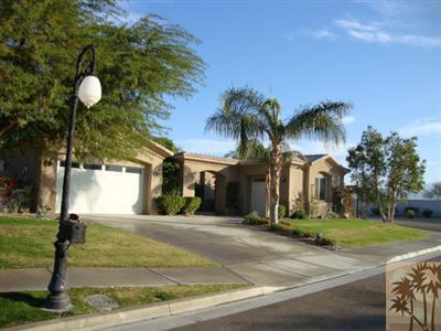 2 Orleans Road Rancho Mirage, CA 92270 - Photo 1 of 8 a front view of house with yard and green space