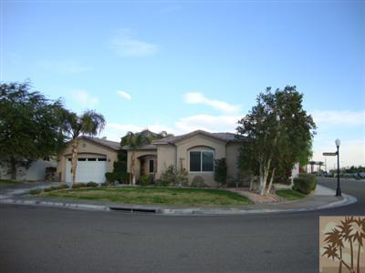 2 Orleans Road Rancho Mirage, CA 92270 - Photo 2 of 8 a front view of a house with a garden